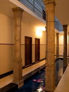a row of columns in a building with a corridor at Aranya in Thanjāvūr