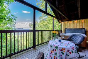 a table and chairs on a deck with a view at Stunning views,LoversretreatwFree Tickets 2 Dollywood,Anakeesta,Ziplining,Aquarium,Arts&CraftsDist in Sevierville