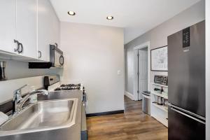 a kitchen with a sink and a stove at Cozy Cottage in the Heart of Hyde Park home in Cincinnati