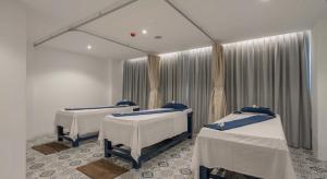a room with three beds and a mirror at Oasis in CityGate 1BR Suite in Kamala Beach +71 photos