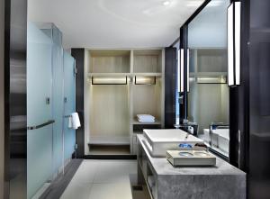 a bathroom with a sink and a large mirror at Echarm Hotel Nanning Wuming in Wuming +233 photos