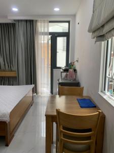a room with a table and a bed and a dining room at Hoang Hoa Tham Apartment in Nha Trang