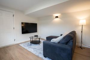 a living room with a couch and a tv at Peaceful Suite near Vernon Armstrong Brand New in Armstrong +19 photos