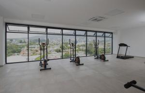 a gym with rows of exercise bikes in a room with windows at Un lugar especial en San Salvador in San Salvador