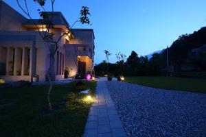 a pathway leading to a house at night at Manor Le Rayon Vert in Jian