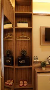 a wooden book shelf with plants in it at Hotel Cikini in Jakarta +16 photos