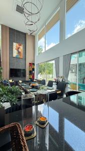 a dining room with a glass table and chairs at De Flourishing Hill Pool Villa , Cha Am in Ban Nong Chaeng +53 photos