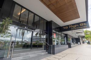 a store front of a building with glass windows at High Street Apartments Toowong in Brisbane
