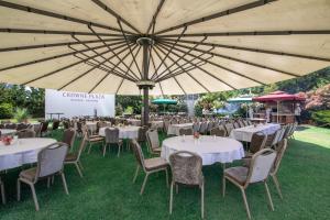 a group of tables and chairs under a large umbrella at Crowne Plaza Istanbul Oryapark by IHG in Istanbul