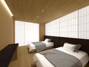 a bedroom with two beds and a large window at Hakuba Amber Resort by Jade Group in Hakuba +225 photos