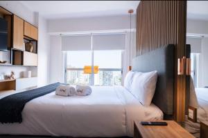 a bedroom with a white bed with two pillows on it at G15 Apartments by Vibrant in Lima