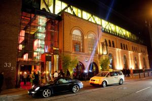 two cars parked in front of a building at night at east Hotel Hamburg in Hamburg