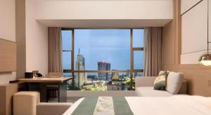 Postelja oz. postelje v sobi nastanitve Zhangjiagang Guomao Hotel