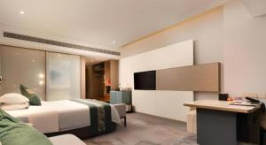 Postelja oz. postelje v sobi nastanitve Zhangjiagang Guomao Hotel