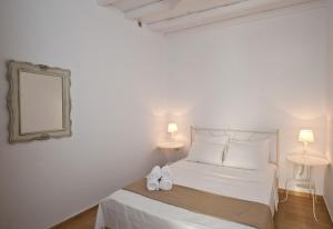 Postel nebo postele na pokoji v ubytování Sea Wind Apartments