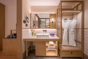 a bathroom with a sink and a mirror at 武汉汉口金融中心万象城漫心酒店 in Wuhan