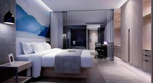 Postel nebo postele na pokoji v ubytování Shenzhen Hanyong Hotel Fuyong Branch