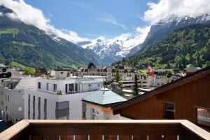 a view of a city with mountains in the background at Hotel Central in Engelberg