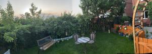a backyard with a table and benches and a fence at Chez Little Black Cat in Patrington