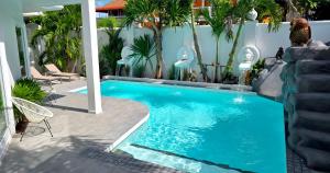a swimming pool with a water slide next to a building at NEBULAND Luxury Pool Villa Pattaya Walking Street 7 Bedrooms in Pattaya South
