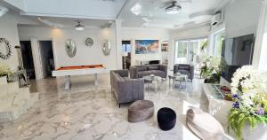 a living room with couches and a pool table at NEBULAND Luxury Pool Villa Pattaya Walking Street 7 Bedrooms in Pattaya South