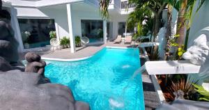 a swimming pool with a teddy bear sitting next to it at NEBULAND Luxury Pool Villa Pattaya Walking Street 7 Bedrooms in Pattaya South +22 photos