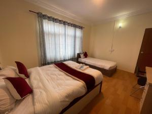 Postel nebo postele na pokoji v ubytování Hotel Jigmeling Appartments