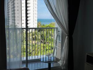 a room with a balcony with a view of the ocean at Seaview Condo - Hua Hin in Hua Hin