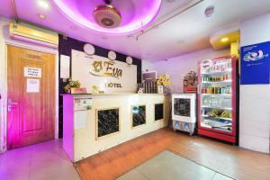 a restaurant with a pink door and a counter at Belvilla in District 8 Near Ben Thanh Market Formerly Eva Hotel in Ho Chi Minh City