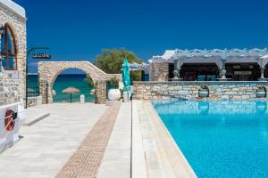 a swimming pool in a villa with a resort at Contaratos Beach Hotel in Naousa