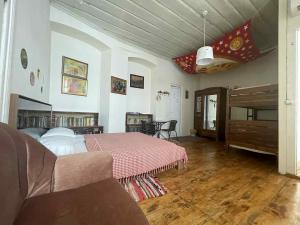 a bedroom with a bed and a couch in a room at Nana's Guest House in Sighnaghi