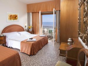 Postel nebo postele na pokoji v ubytování Hotel Dea
