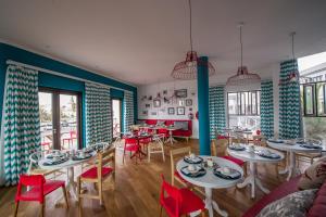 a dining room with tables and red chairs at The Delight Swakopmund in Swakopmund