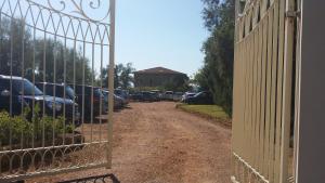 a gate with cars parked in a parking lot at Cala Dei Mori in Livorno