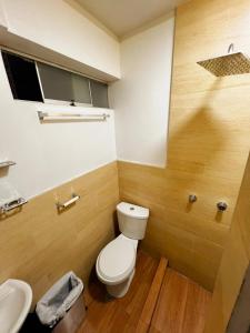 a bathroom with a toilet and a sink at Huamanga plaza in Ayacucho +13 photos
