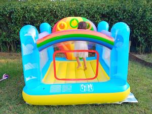 a little girl playing on a bounce house in the grass at Noufara Apartments in Nea Mesangala +48 photos