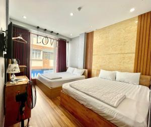 Voodi või voodid majutusasutuse Winny Hotel Ninh Kieu Quay toas