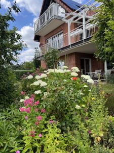 a garden of flowers in front of a house at Ferienwohnung Landidylle in Friedrichshausen