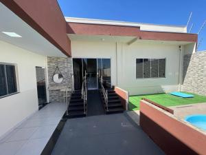 a view of a building with stairs and grass at Pousada Império in Chapada dos Guimarães