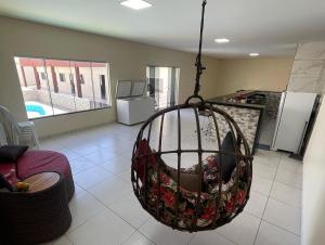 a room with a basket hanging from the ceiling at Pousada Império in Chapada dos Guimarães
