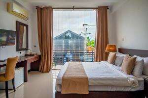 a bedroom with a bed and a large window at Beverly Beach Hotel & Transit in Negombo