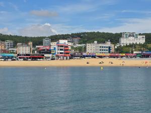 a view of a beach with a city and buildings at 경주펜션 Gyeongju Pension in Incheon