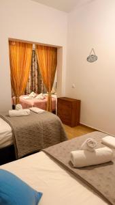 a hotel room with two beds and a window at Rida Village Ksamil Island in Ksamil