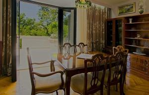 a dining room with a wooden table and chairs at Holiday Home Villa Laura - Krk by Villas Guide in Krk