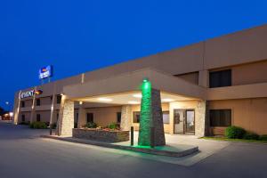 a hospital building with a green light in front of it at Baymont by Wyndham Green Bay in Green Bay