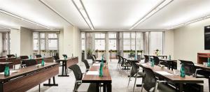 uma sala de jantar com mesas, cadeiras e janelas em Hyatt Centric Times Square New York em Nova Iorque