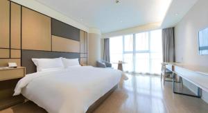 Postel nebo postele na pokoji v ubytování JI Hotel Shanghai Zhangjiang