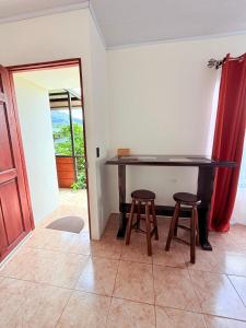 a table and two stools in a room with a door at Estancia Rincón Verde in Fortuna +20 photos