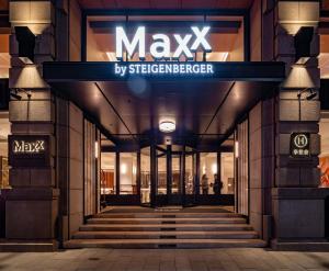 a building with a sign that reads maxx by streetcarier at Maxx by Steigenberger on the Bund Shanghai in Shanghai