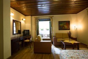 a room with a bed and a living room at Hotel Ivanov Konak in Cetinje